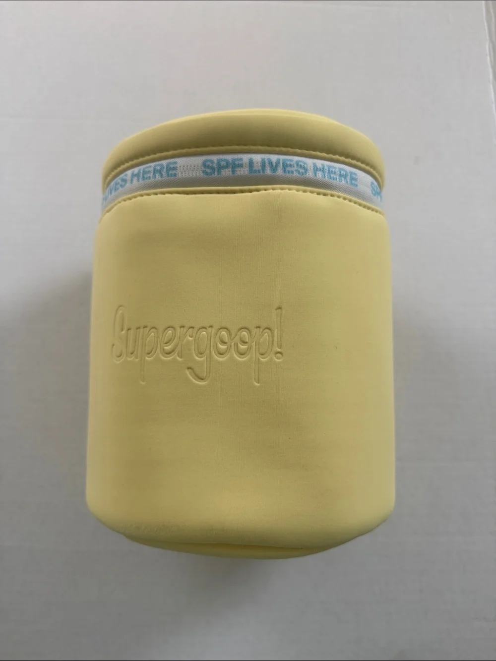 Supergoop! Pale Yellow Neoprene Sunscreen Pouch with Blue Accent